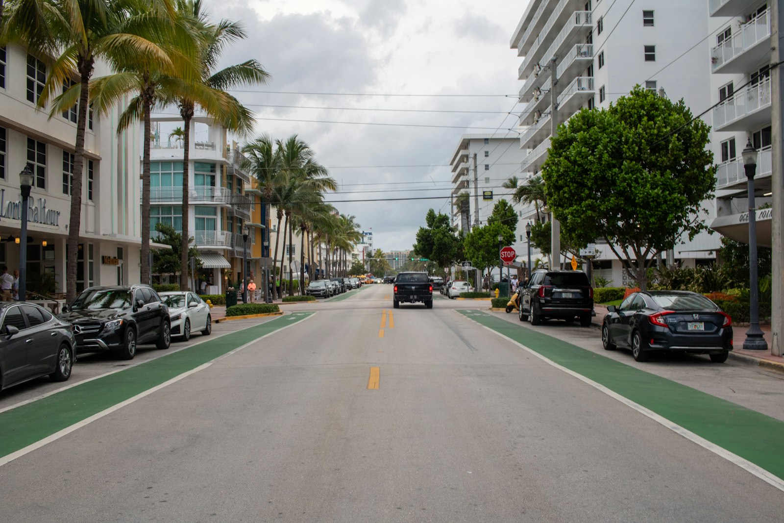 A street lined with tall buildings and palm trees